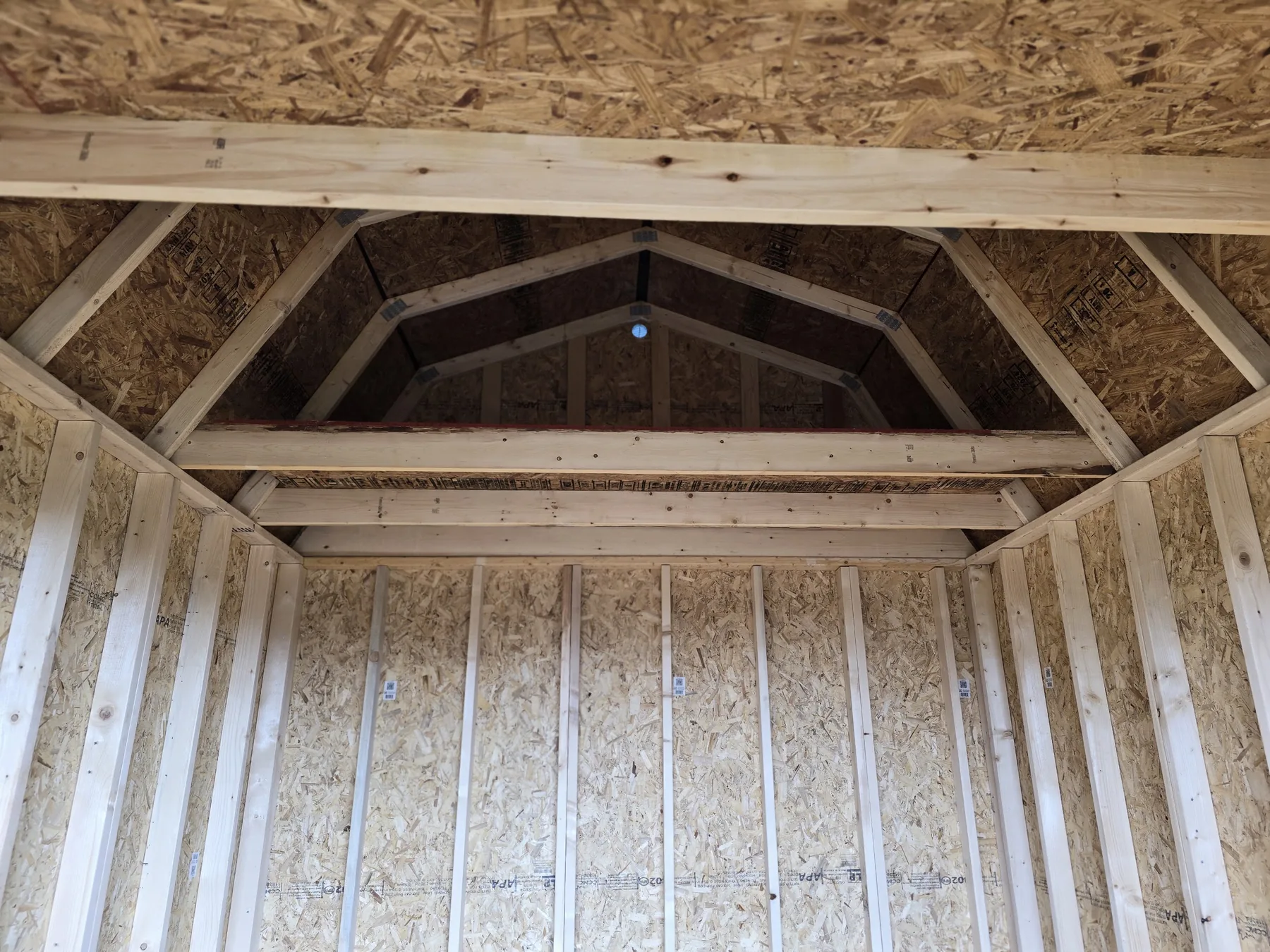 Exposed loft framing inside a Premier lofted barn shell